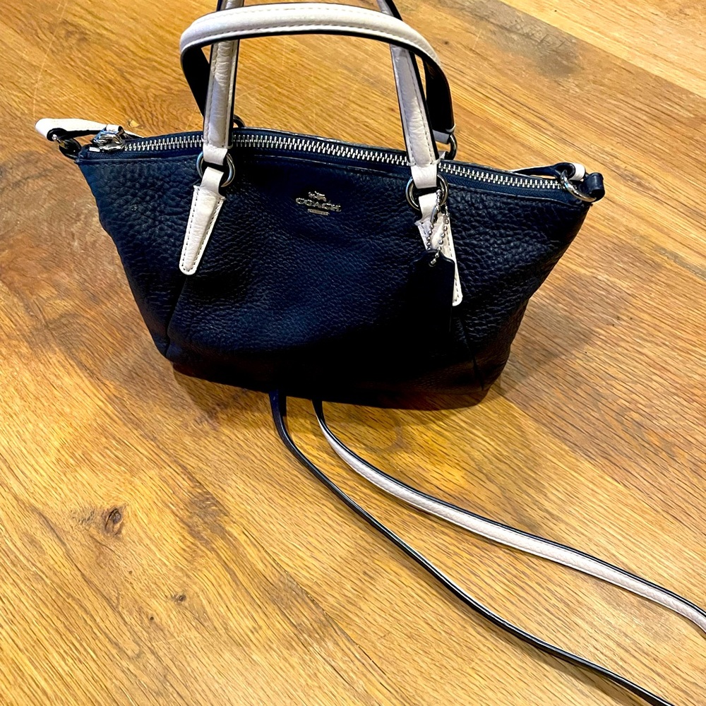 Navy blue and cream coach crossbody handbag.